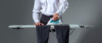 Man ironing black trousers