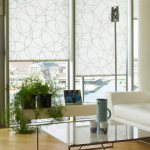 Panoramic living room windows with roller blinds made of light fabric